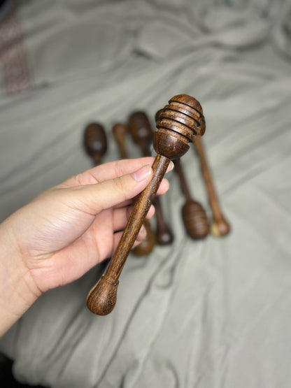 Dark wooden honey dipper in use drizzling honey Pure Woodique