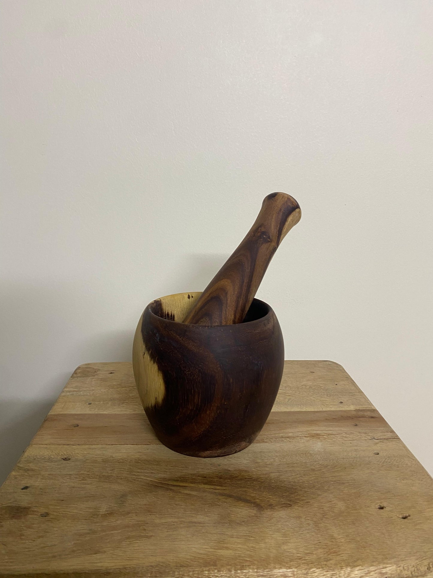 Wooden mortar and pestle set styled with spices on kitchen counter Pure Woodique