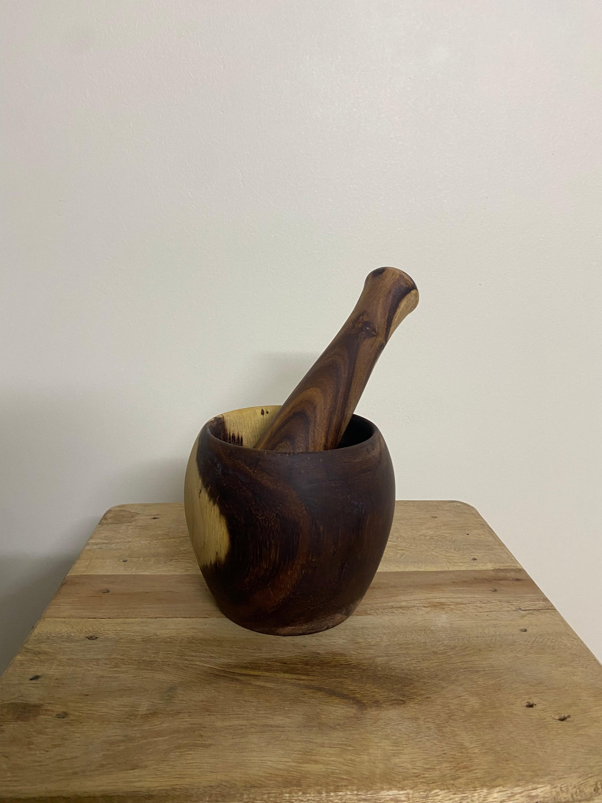Wooden mortar and pestle set styled with spices on kitchen counter Pure Woodique